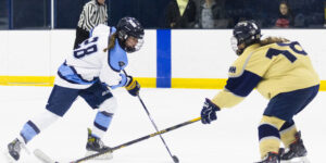 Peabody's Abby McInerney and St. Mary's Haylie Grossman battle for the puck.